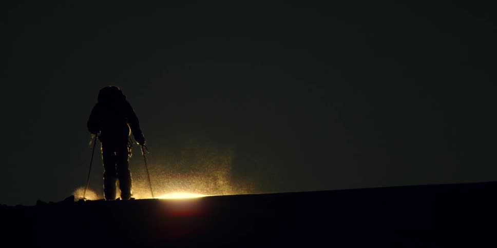 A man skiing at night