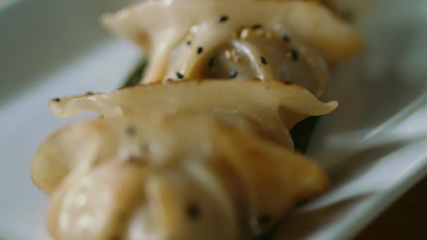 Dumplings are are on the plate with sauce