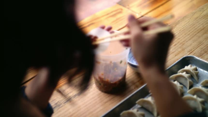 A woman cooking potstickers