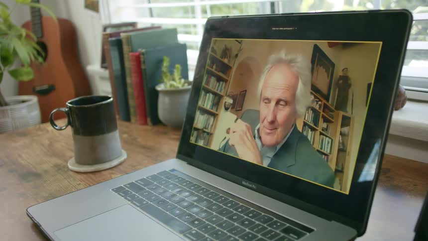 A man is on a laptop screen during a video call