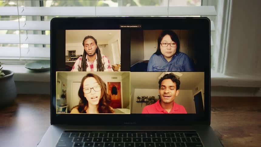 Four people are talking on the laptop conference