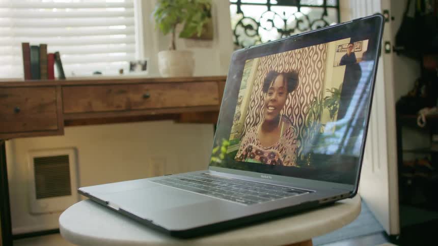 Young woman on a video call in a laptop at home