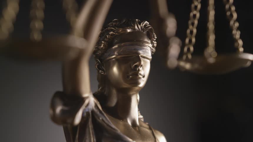 Bronze sculpture of lady justice with blindfold holding scales