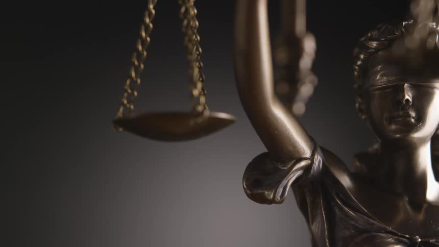 A lady justice statue is in the room