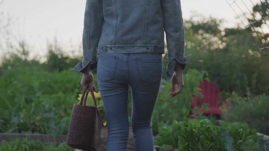 A female walking through a garden