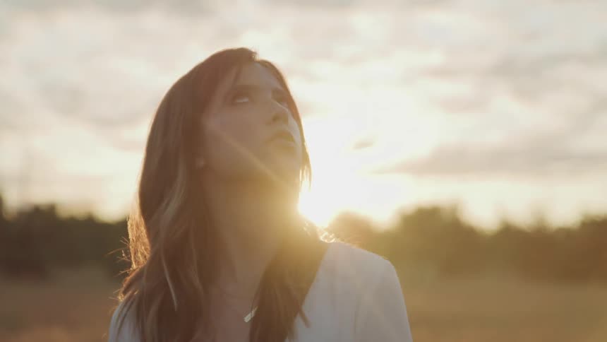 A woman is watching the sunrise