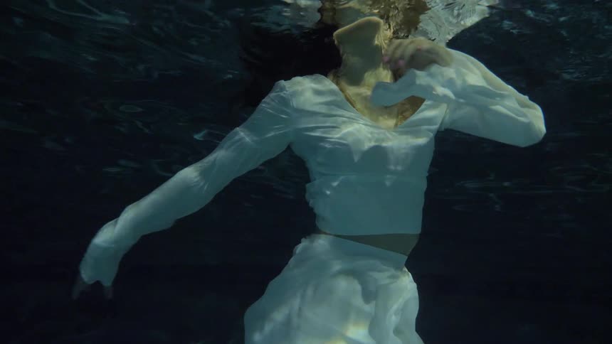 A woman is wading in the water