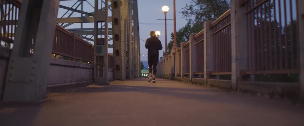 A person running on a path at dusk