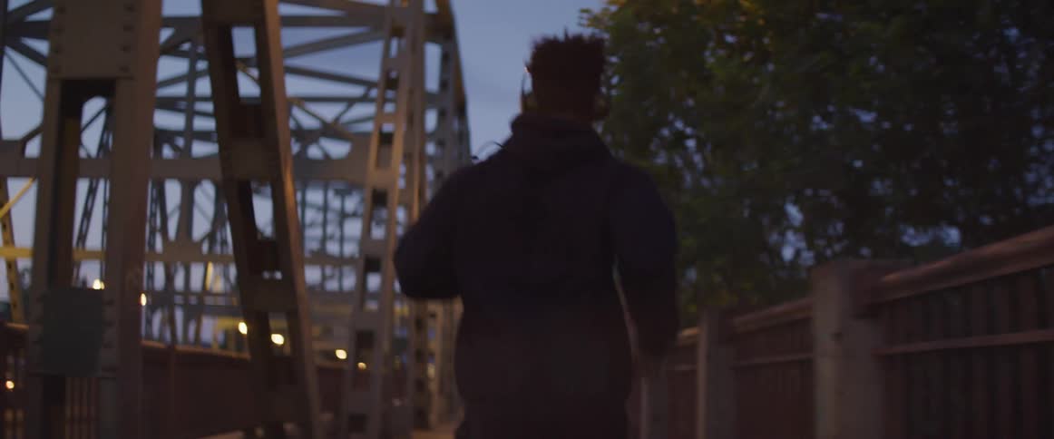 A man running outside in the evening
