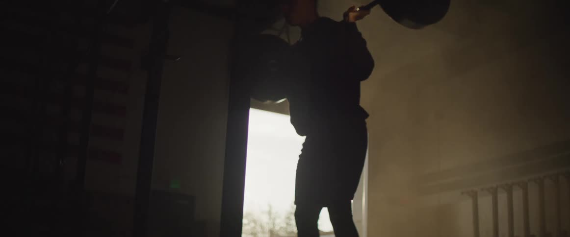 A man if lifting weights indoors