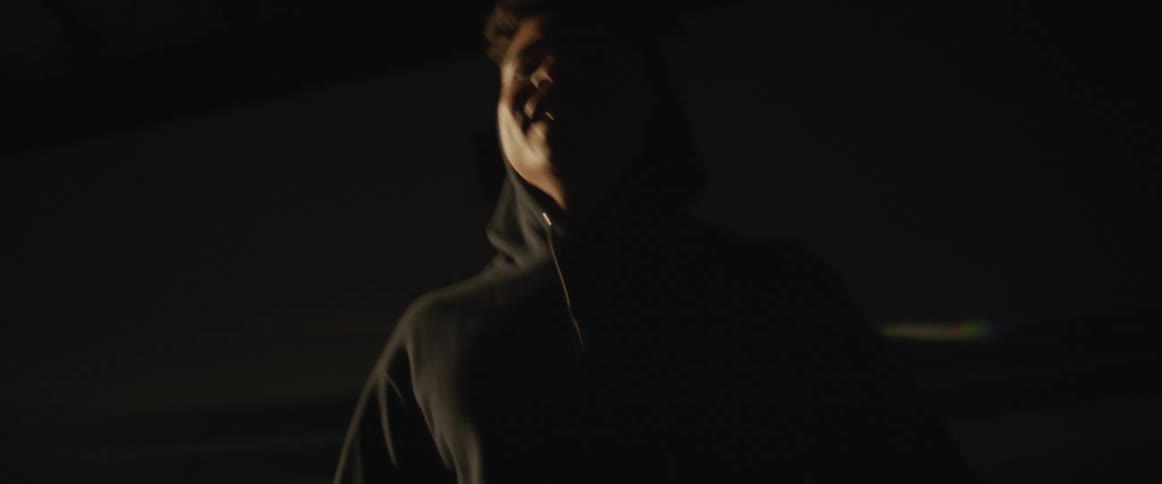 A man is working out in a room at dusk