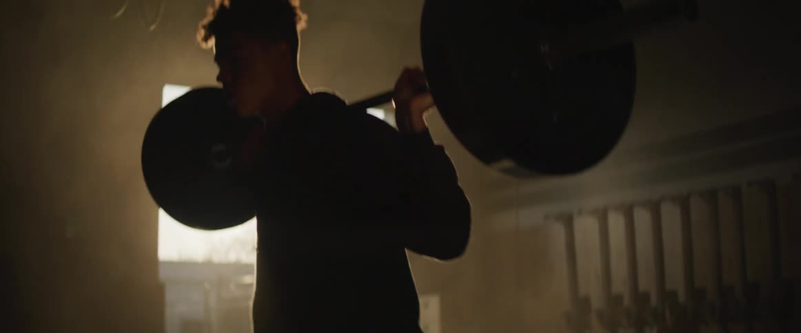 A man doing squats with a barbell