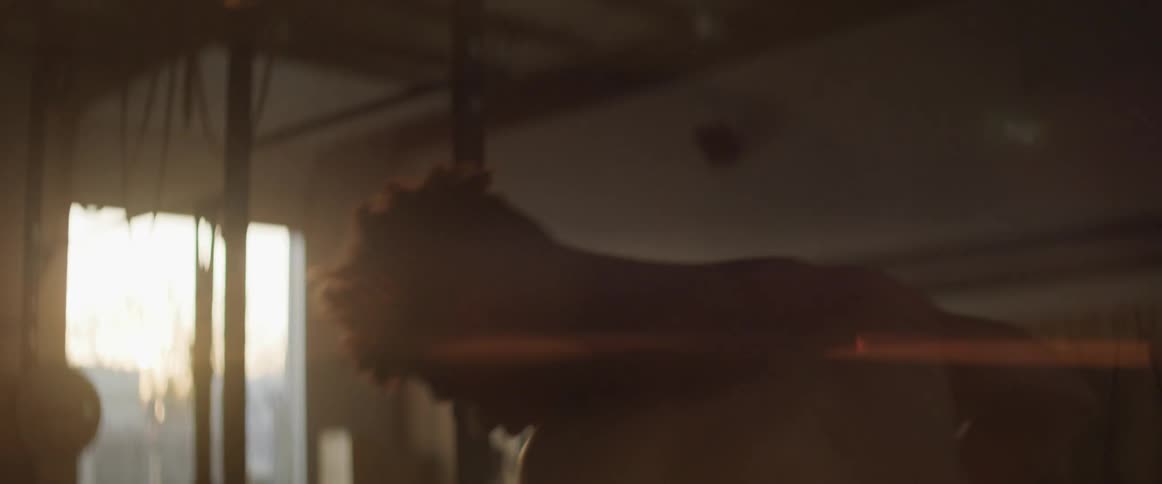 A male boxing in a dark gym