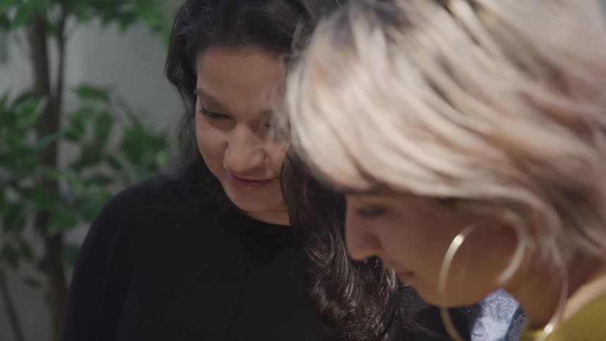 Two women looking down at something