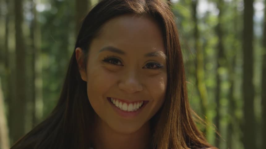 A woman turns her head up and smiles