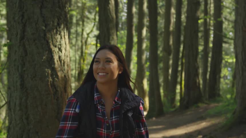 A young woman hiking in a forest