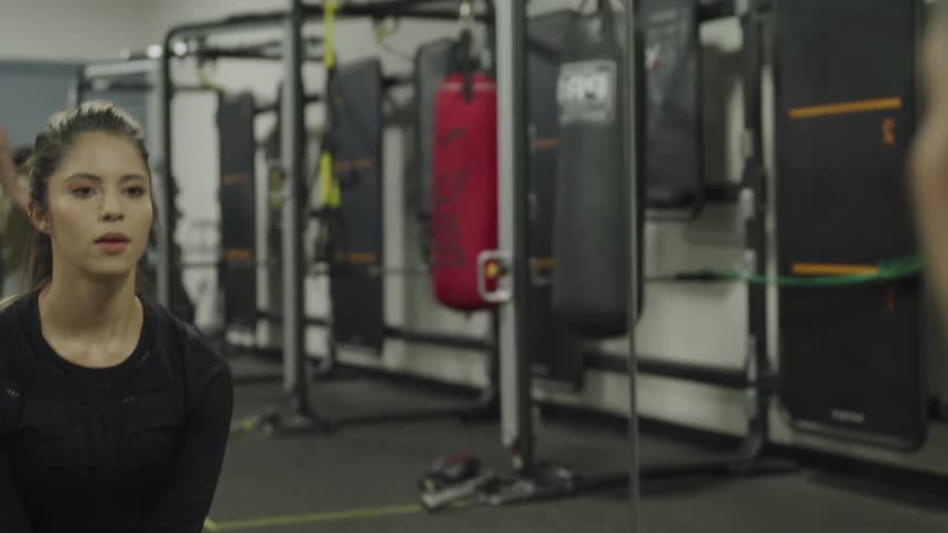 People are in a gym and working out