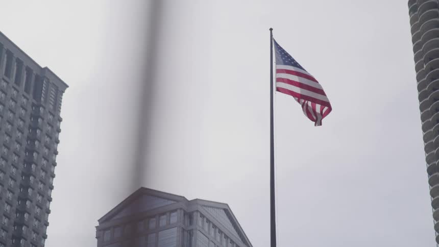 A flag is shown in a downtown city
