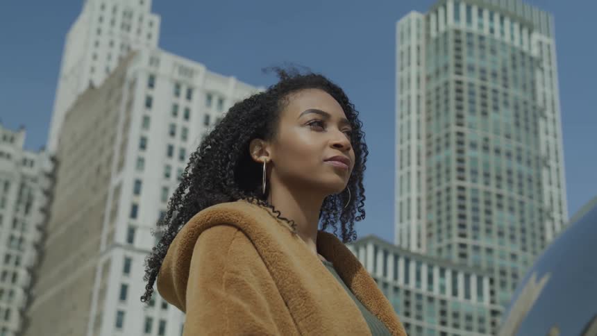 A woman looks around in the city