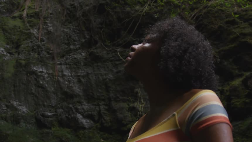 A teenage girl looking up at a canyon