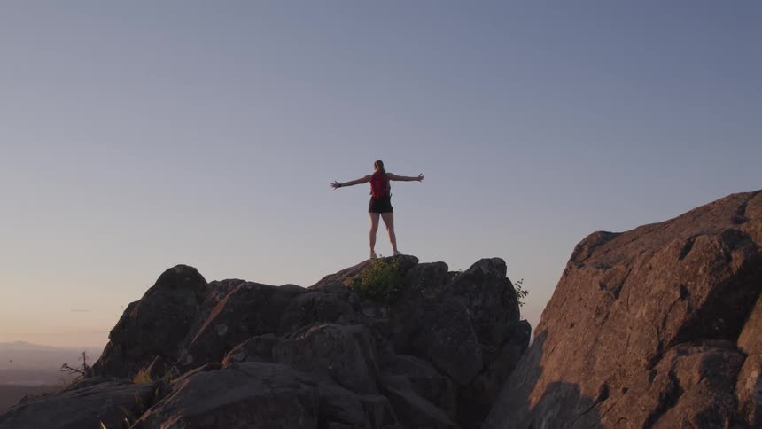 A person is standing ontop of a cliff