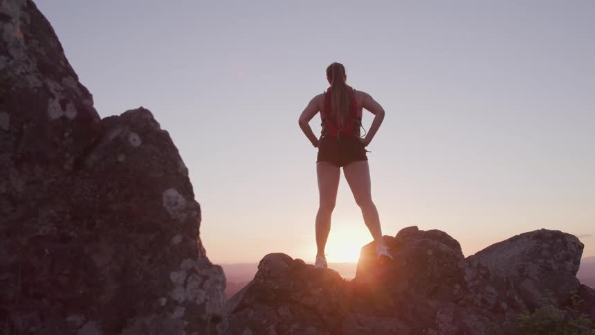 A woman is hiking in a mountain area