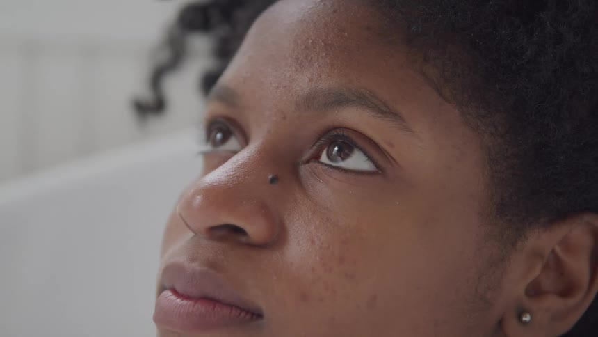 Close up of a young woman relaxing in a bathtub at home