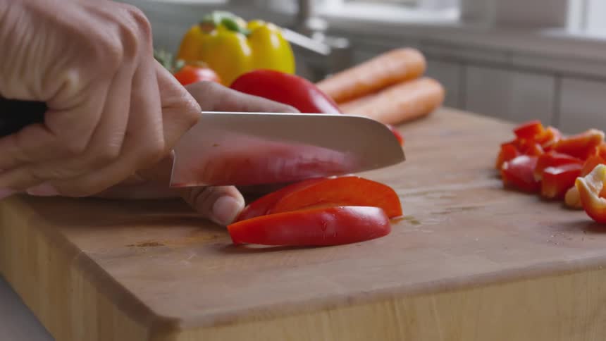 Chopping red pepper on cutting board
