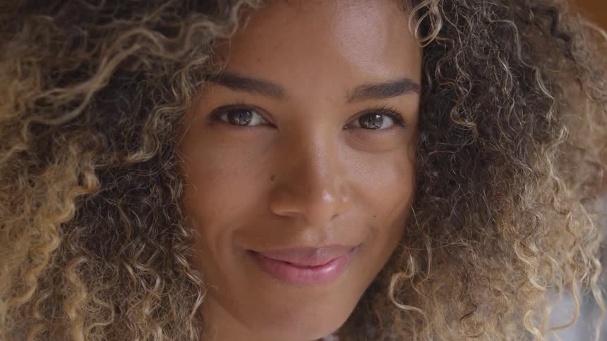 A closeup view of a womans face is displayed