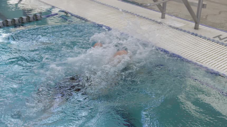 Woman swimming in olympic pool