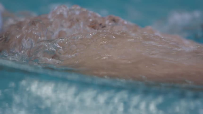 A female swimming in the water