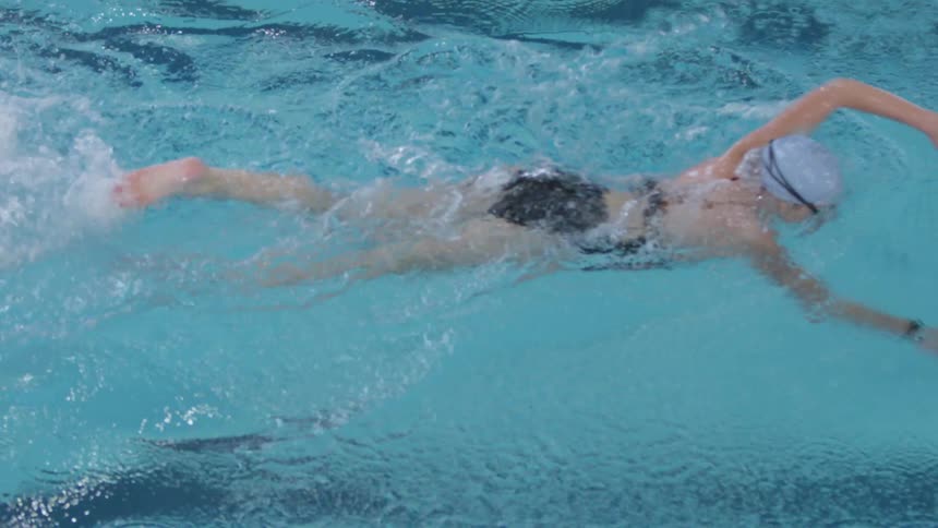 A teenage girl swimming in a pool