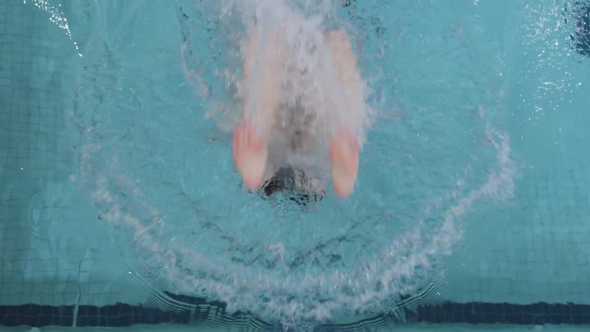 Woman swims in indoor swimming pool