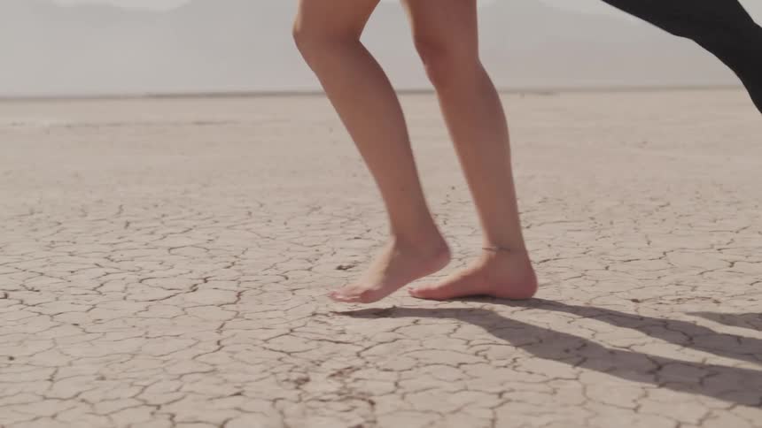 A woman is walking through the desert