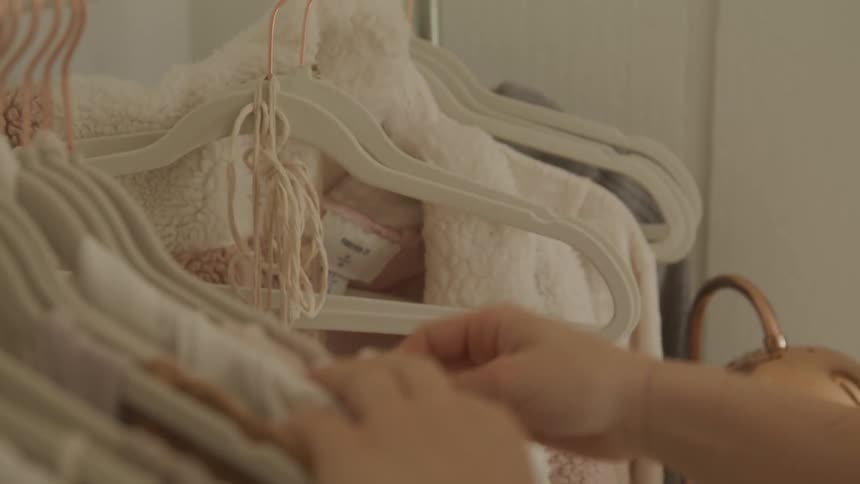 A woman looks through clothes