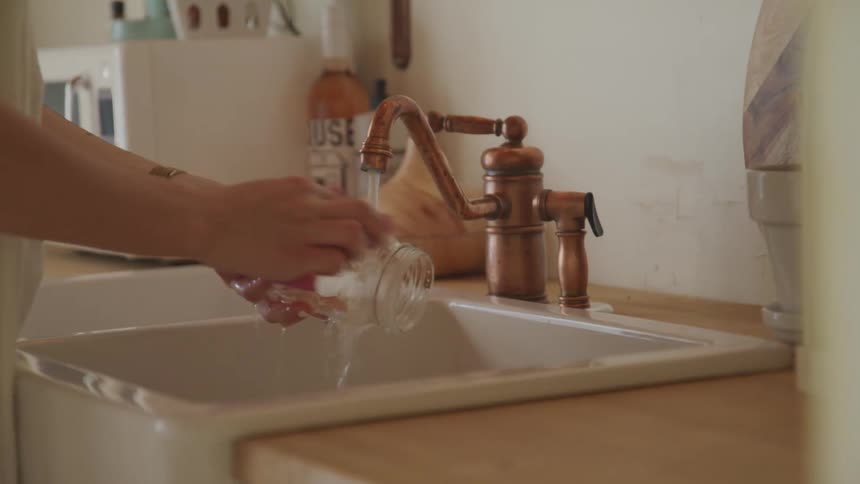 A woman washing dishes at home