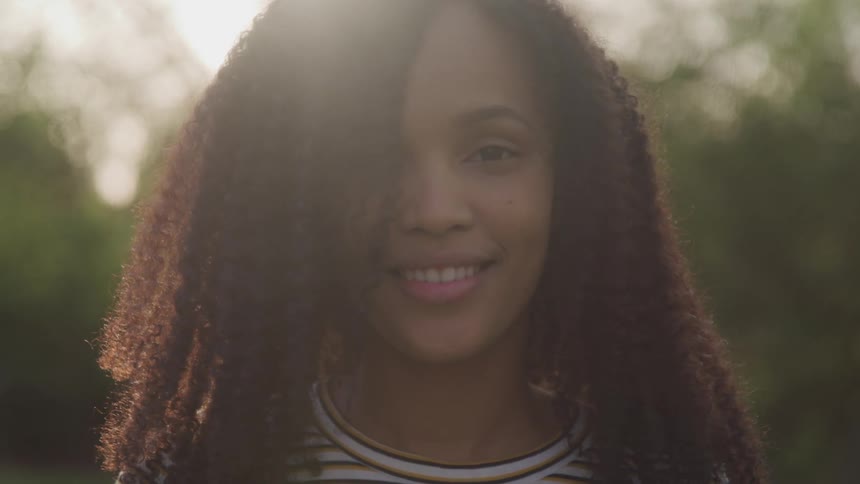 A woman is smiling outside