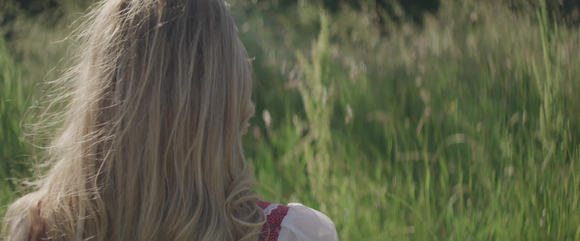 A female in a grassy field