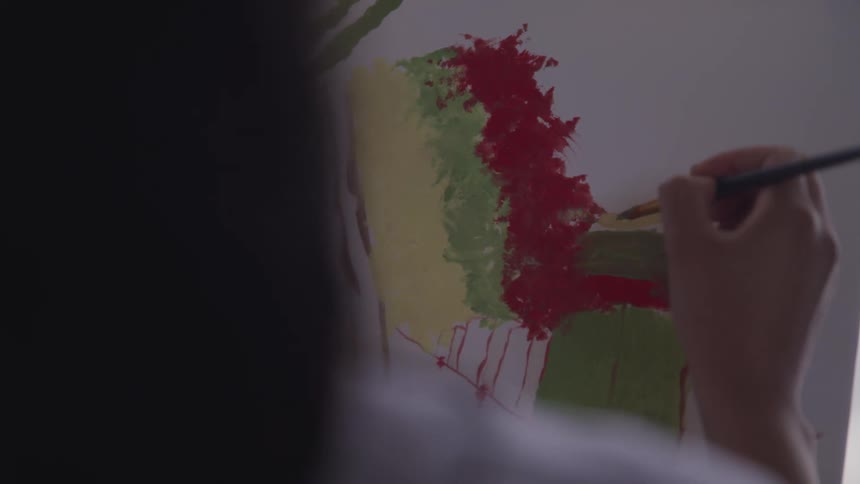 A person painting on a canvas