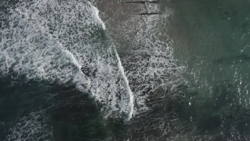 An aerial view of an ocean is displayed