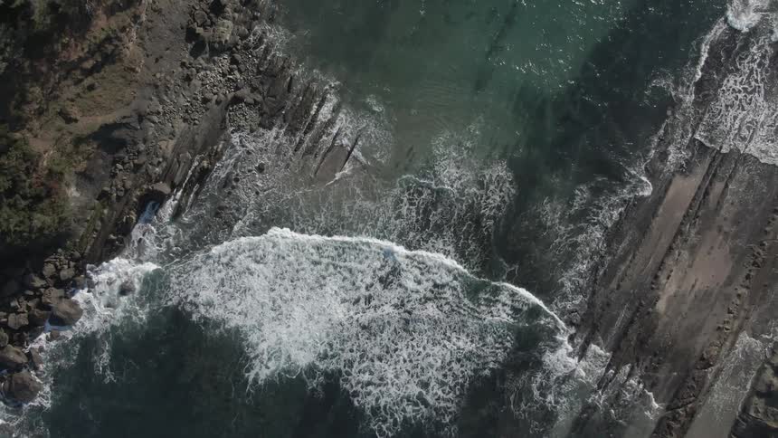 Waves in ocean inlet between shores