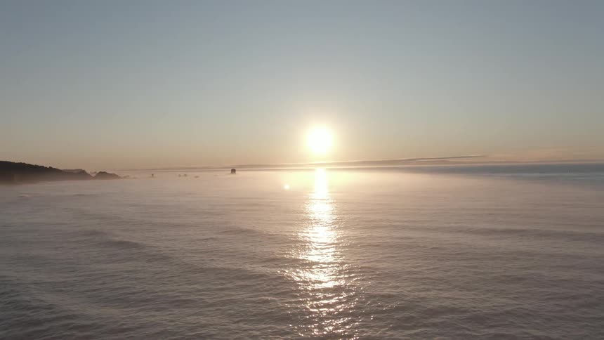 The sun is setting above the ocean