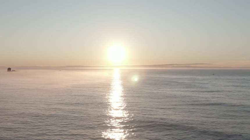 The sun setting over the ocean