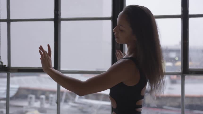 A female posing dance moves in a room