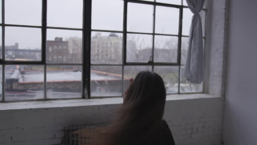 A woman dancing inside her home
