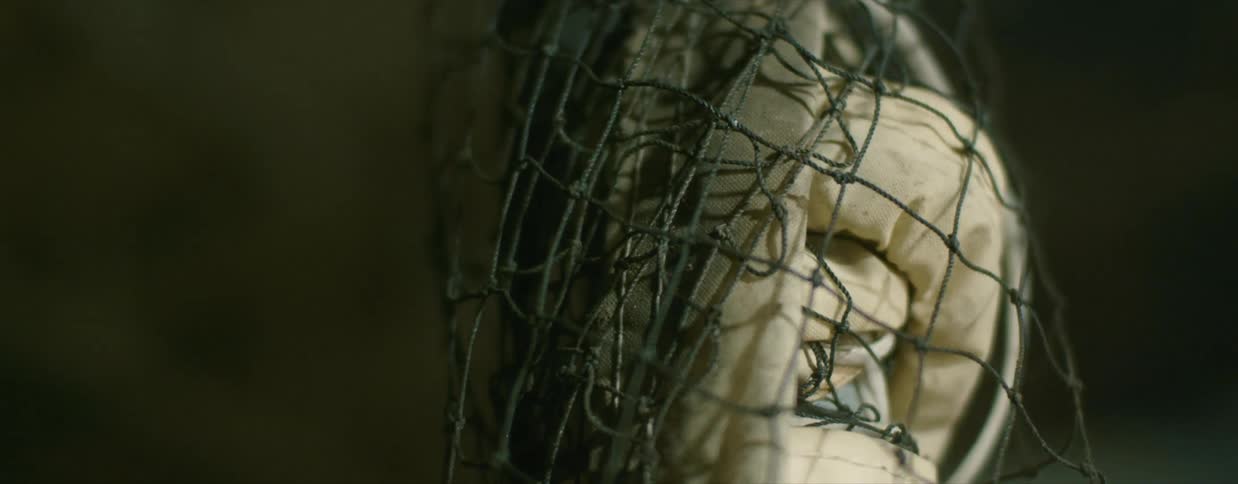 A pole wrapped in cloth in a net