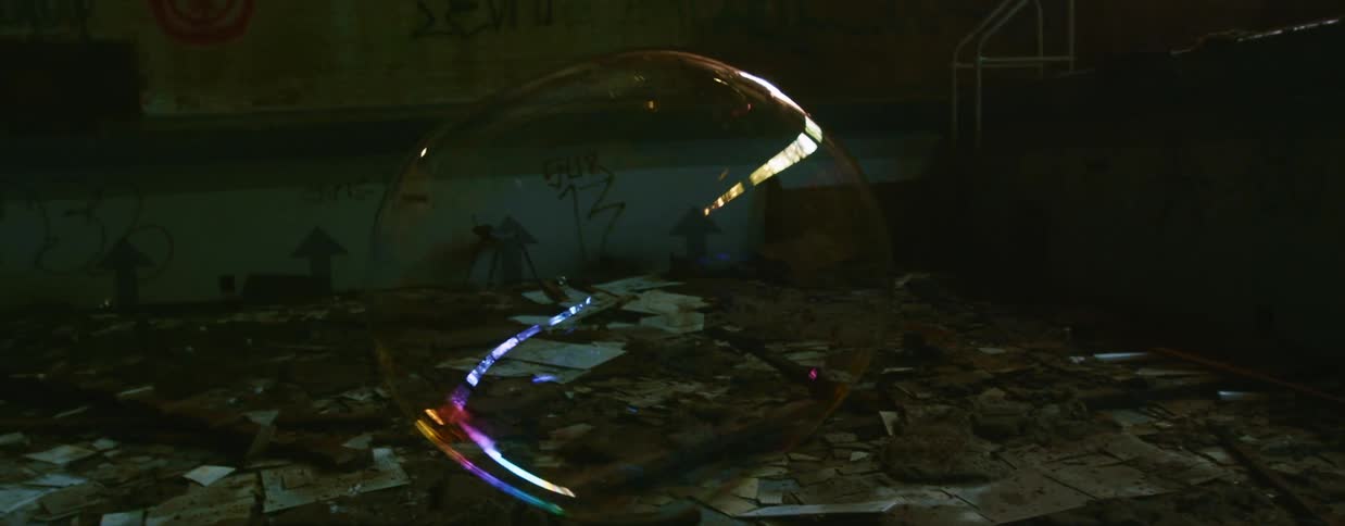 Large bubbles floating in an abandoned building with graffiti