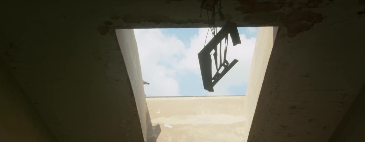 A room with a hole in the ceiling with the sky and clouds above