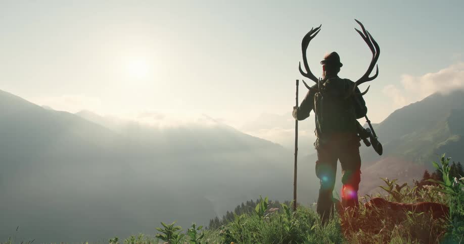 A man is hiking through the wilderness