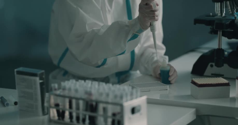 Lab technician transfers samples using pipette